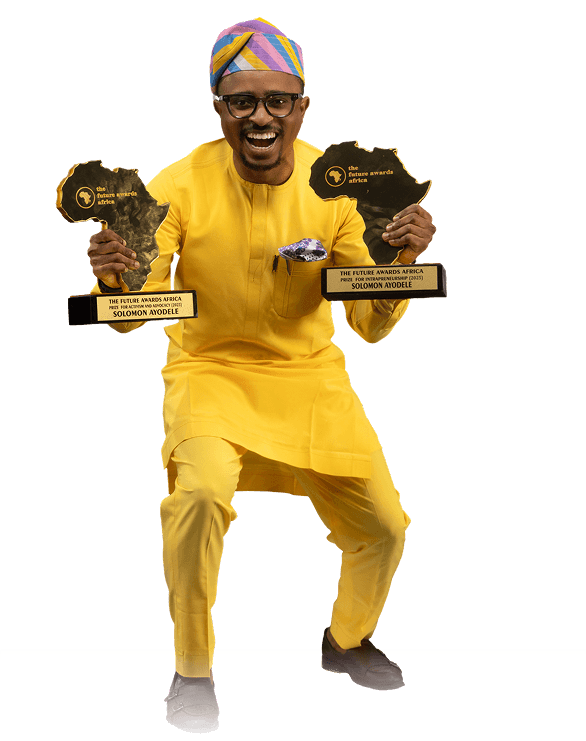 Solomon Ayodele holding two Future Awards Africa plaques